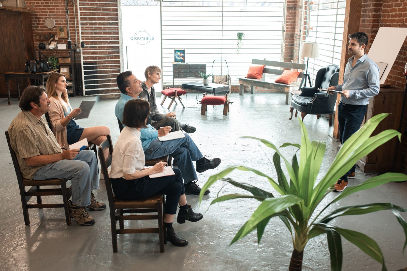 Friends talking in a brick room