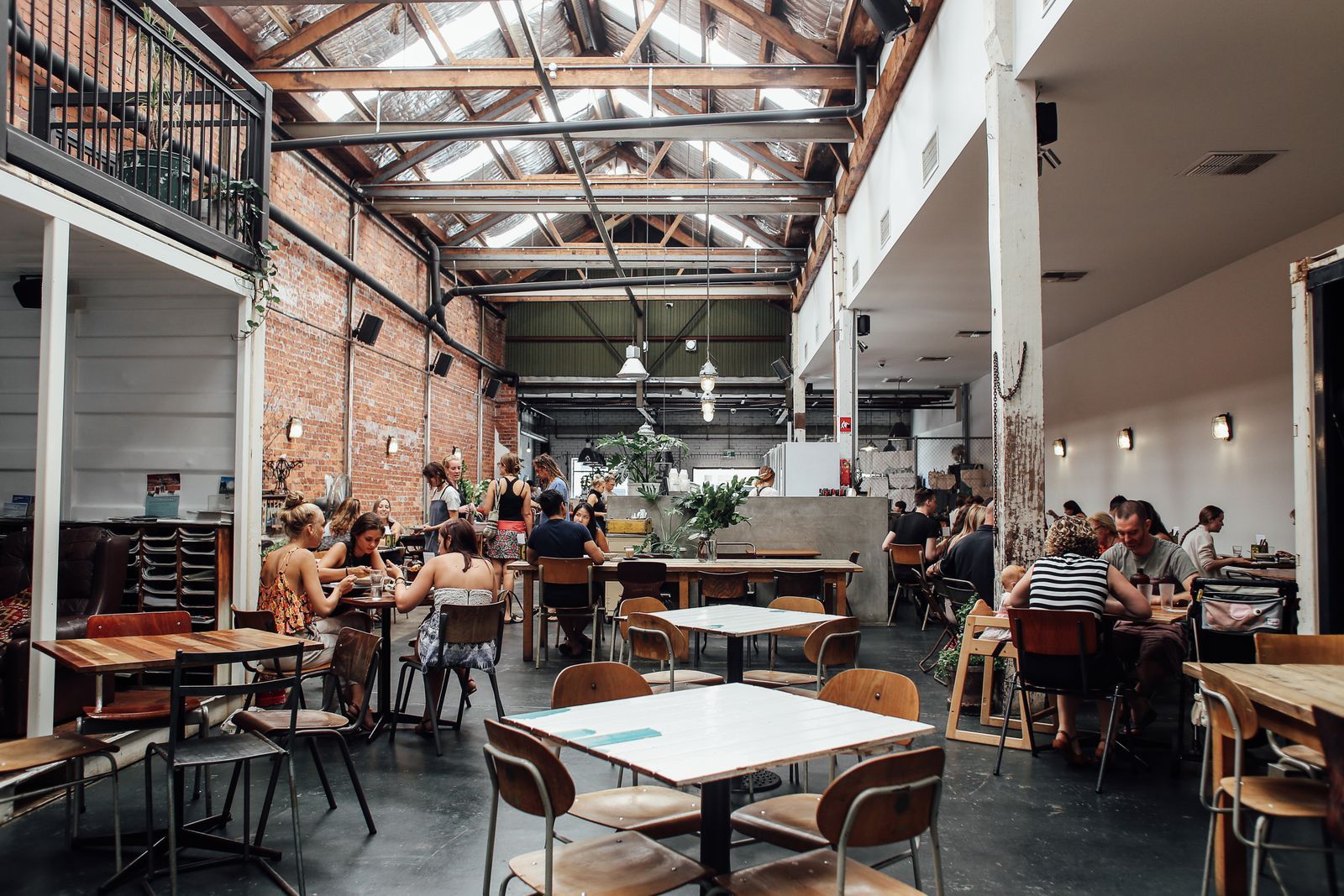 People gathered in a bright brick warehouse hall